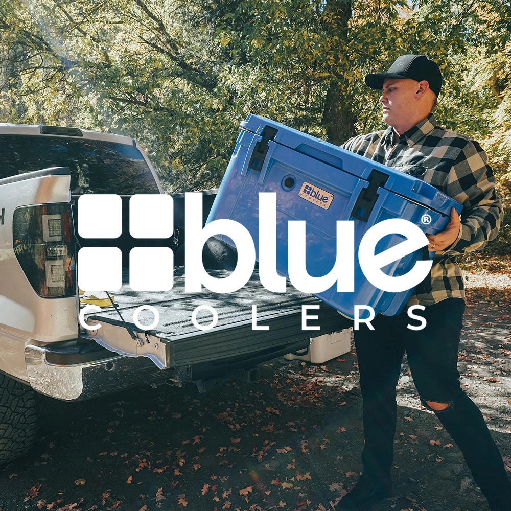 man loading a Blue cooler into a truck