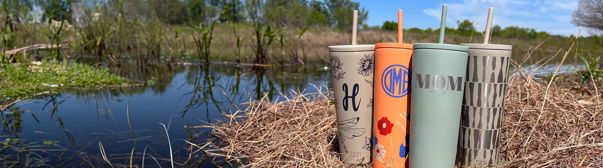 personalized mother's day classic tumblers, sitting by a pond