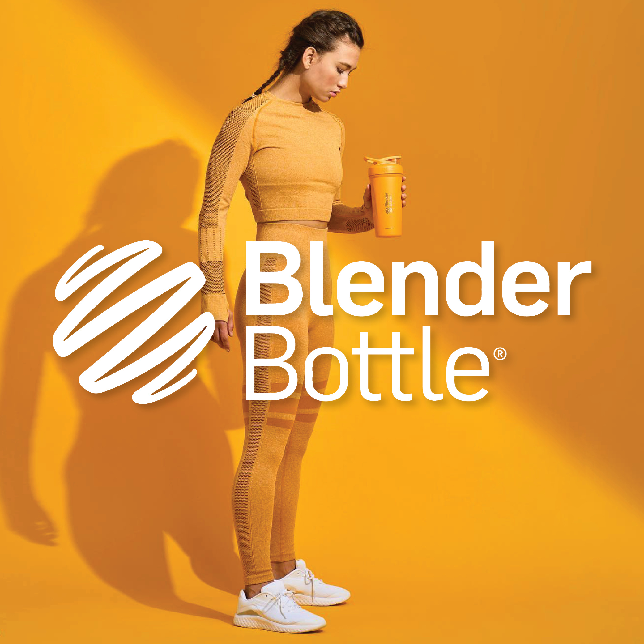 Woman in yellow workout clothes holding yellow blender bottle
