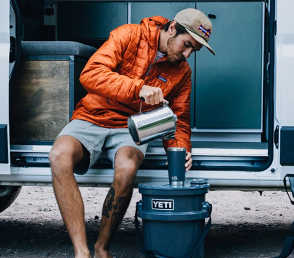Man pouring coffee into Yeti 20 oz tumbler