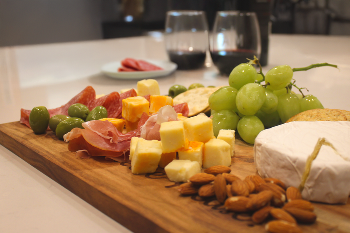 Customized walnut cutting board resting on a counter with fruit