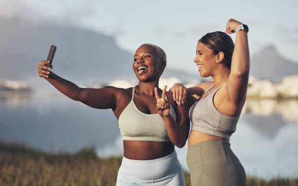 Two Women who are exercising are taking a selfie.