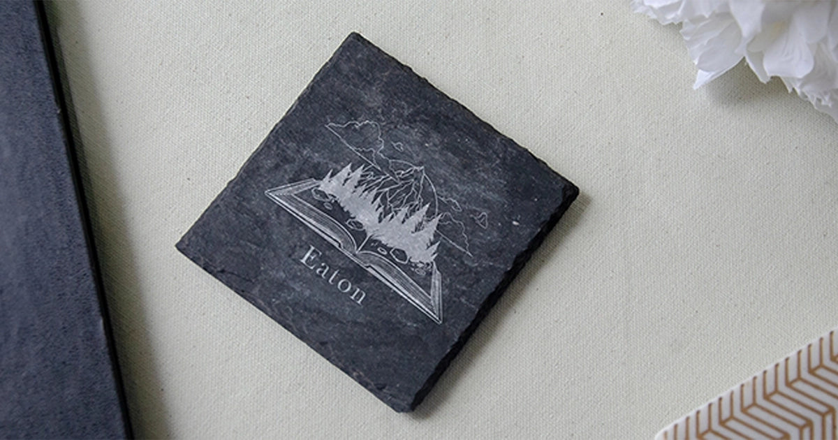 slate drink coaster with personalized engraving of a book on fire