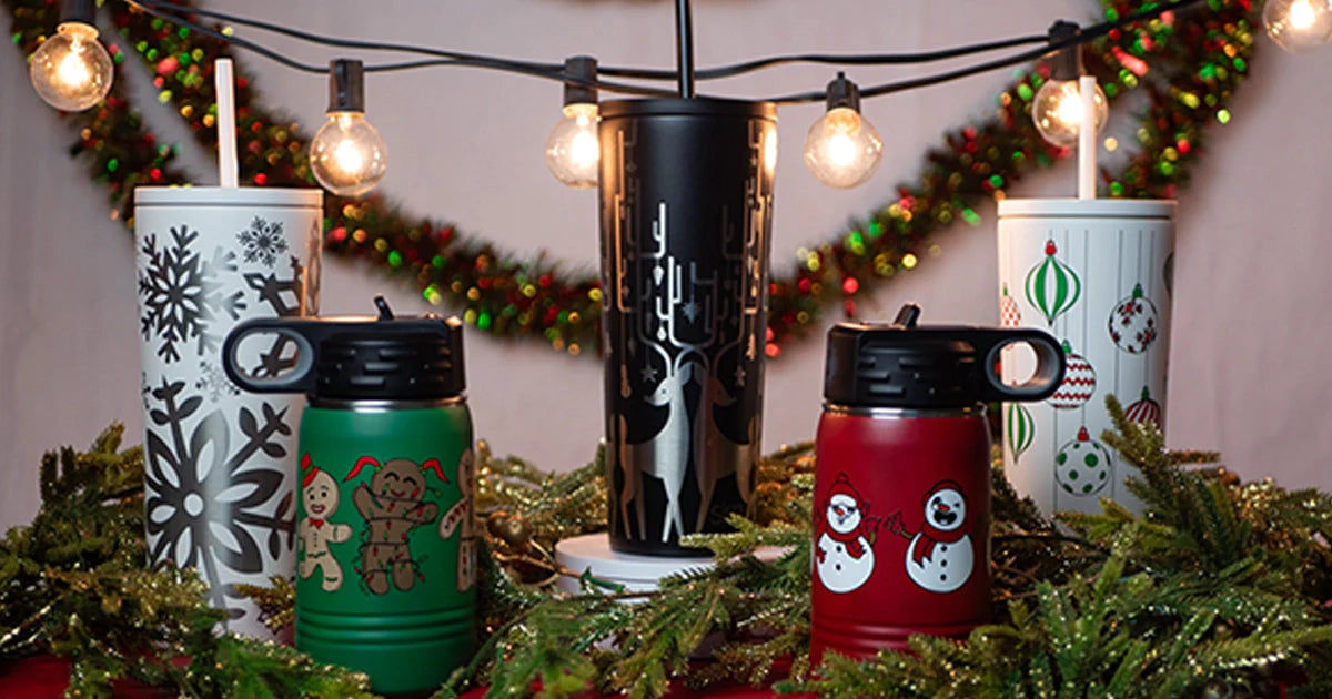 Custom holiday drinkware from custom branding.  Showing insulated bottles and cups with christmas and holiday designs such as snowflakes, snowmen, reindeer, and gingerbread men.