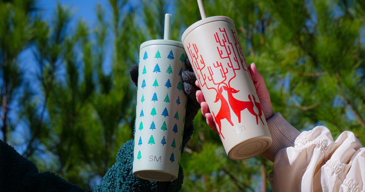 Custom holiday drinkware from custom branding.  Showing insulated bottles and cups with christmas and holiday designs such as snowflakes, snowmen, reindeer, and gingerbread men.