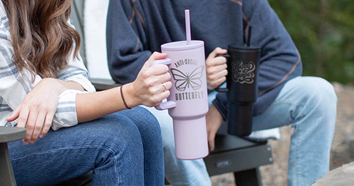 two people holding a straw handle tumbler with custom engraving designs