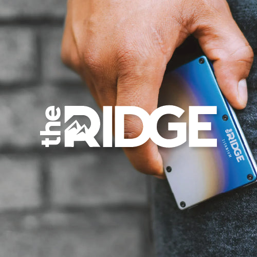Close-up of a mans hand holding a ridge minimalist wallet with ridge logo overlay