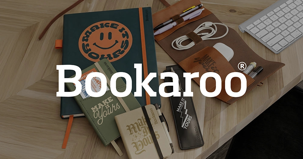 Notebooks and stationery items on a wooden surface with Bookaroo branding.