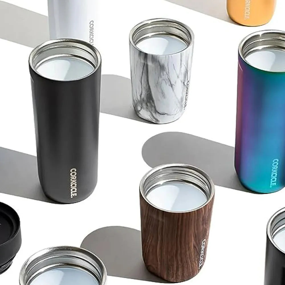 Multiple Corkcicle commuter cups in 9 oz and 17 oz arranged on a table.