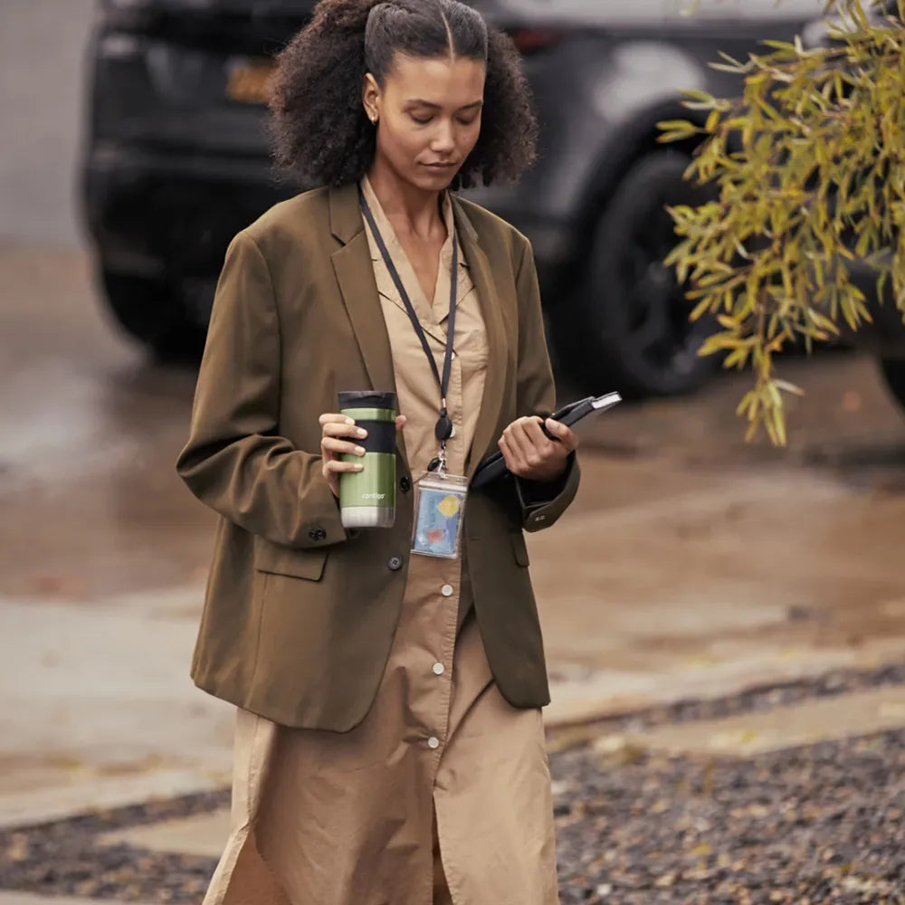 Woman holding 16 oz Contigo Byron Tumber while walking.