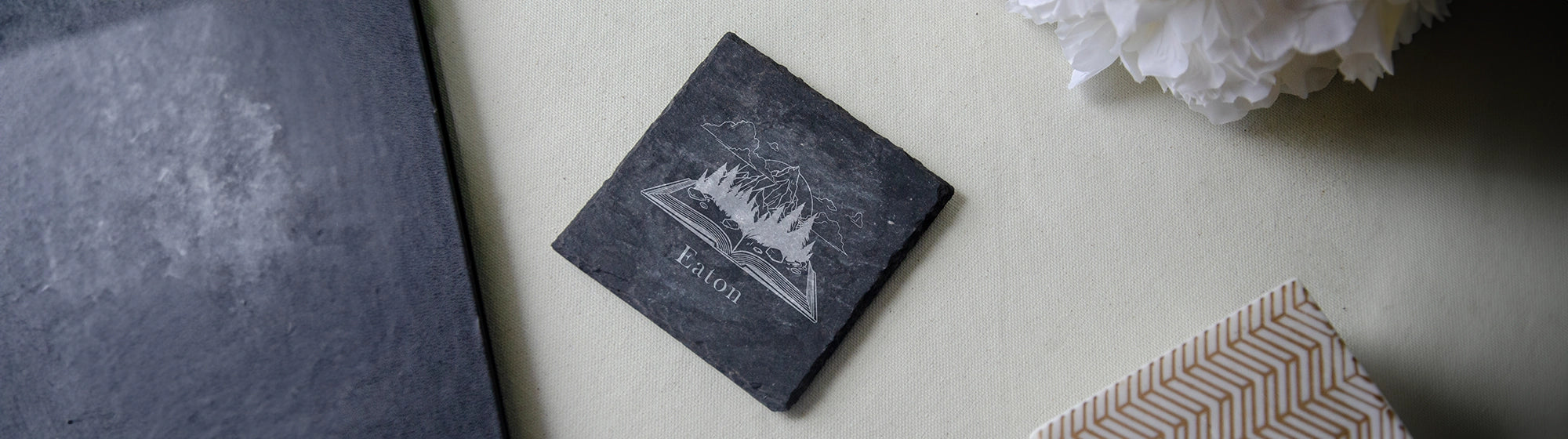 slate drink coaster with personalized engraving of a book on fire