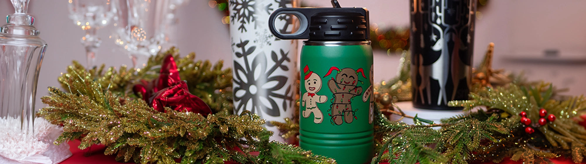 Insulated water bottles and cups from custom branding.  Designs include gingerbread men, snowflakes and reindeer wraps.