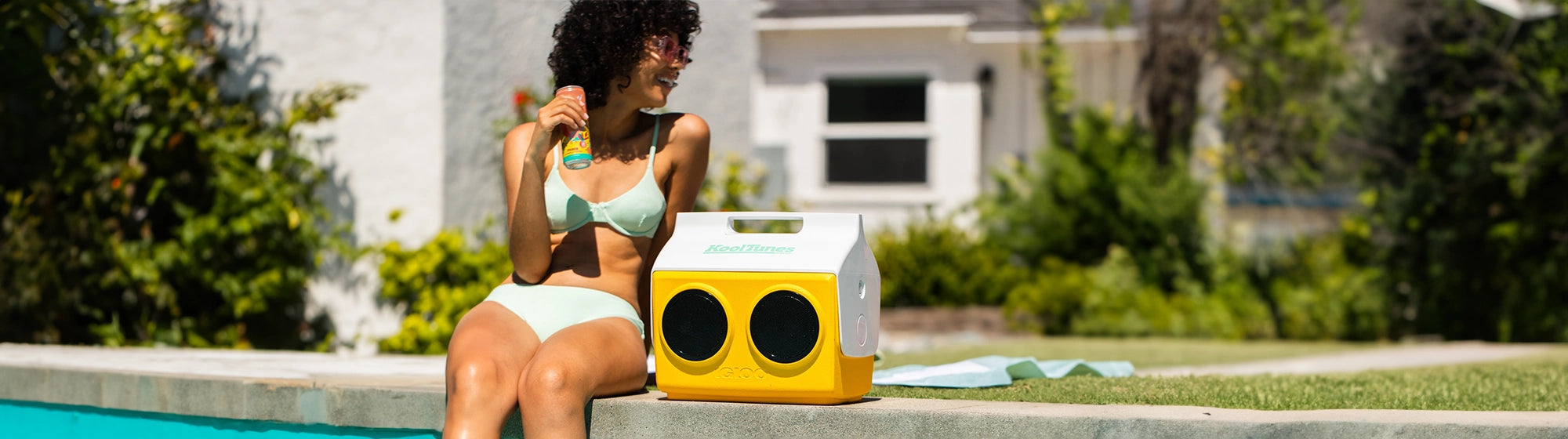 woman with yellow igloo playmate cooler by pool
