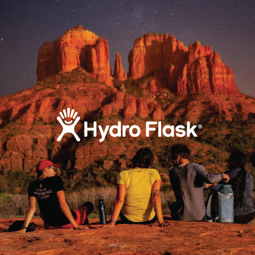 young adults sitting in front of a large land feature with a hydro flask bottle.  Hydro flask logo overlaid