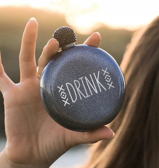 woman holding a brumate glitter flask with personalized name engraved into the finish