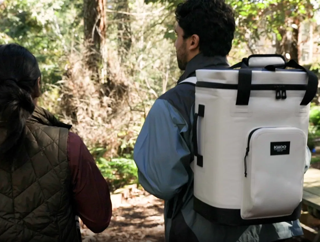 Man carrying Igloo Trailmate 24 can Backpack while hiking.