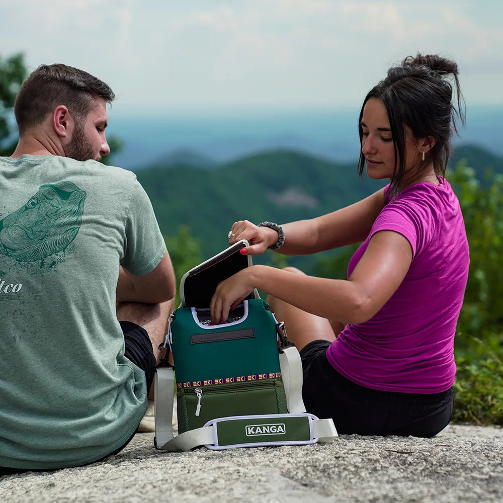 Women reaching into Kanga Pouch while sitting.