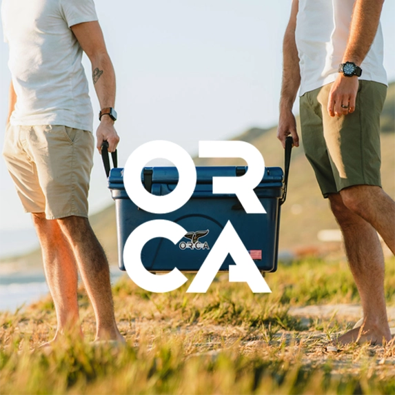 Orca Coolers Logo with two men holding a navy blue ORCA Hard Cooler