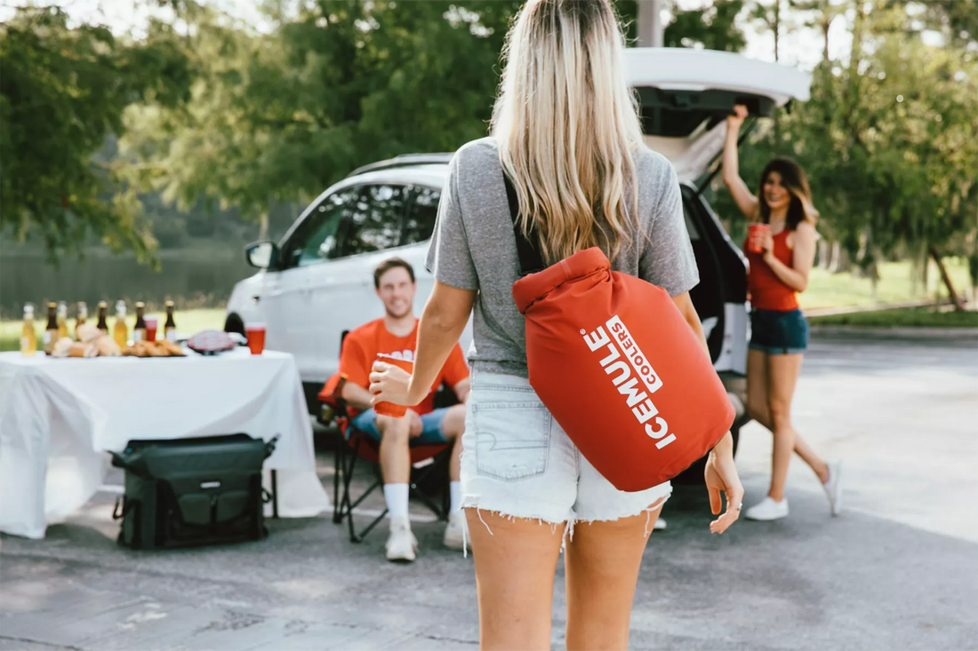 Woman attending tailgate with red Icemule classic cooler