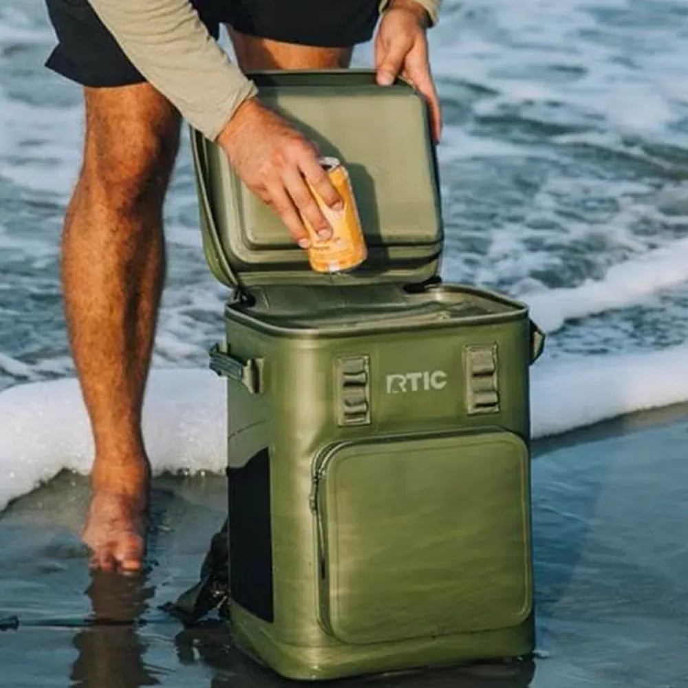 Man pulling can from RTIC Ultra-Tough Backpack Cooler.