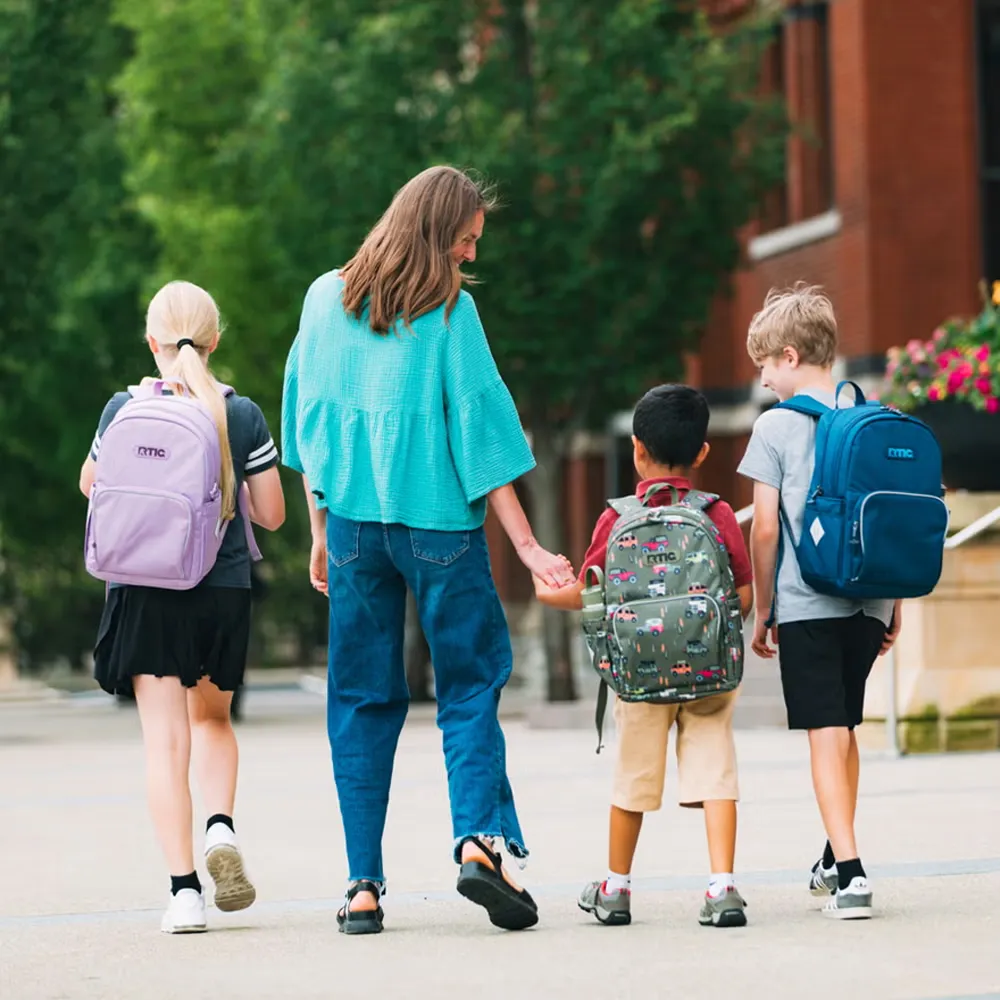 Woman walking with three children carrying RTIC Kids&