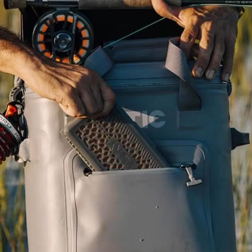 Man taking phone out of Ultra-Tough Soft Cooler Pro.