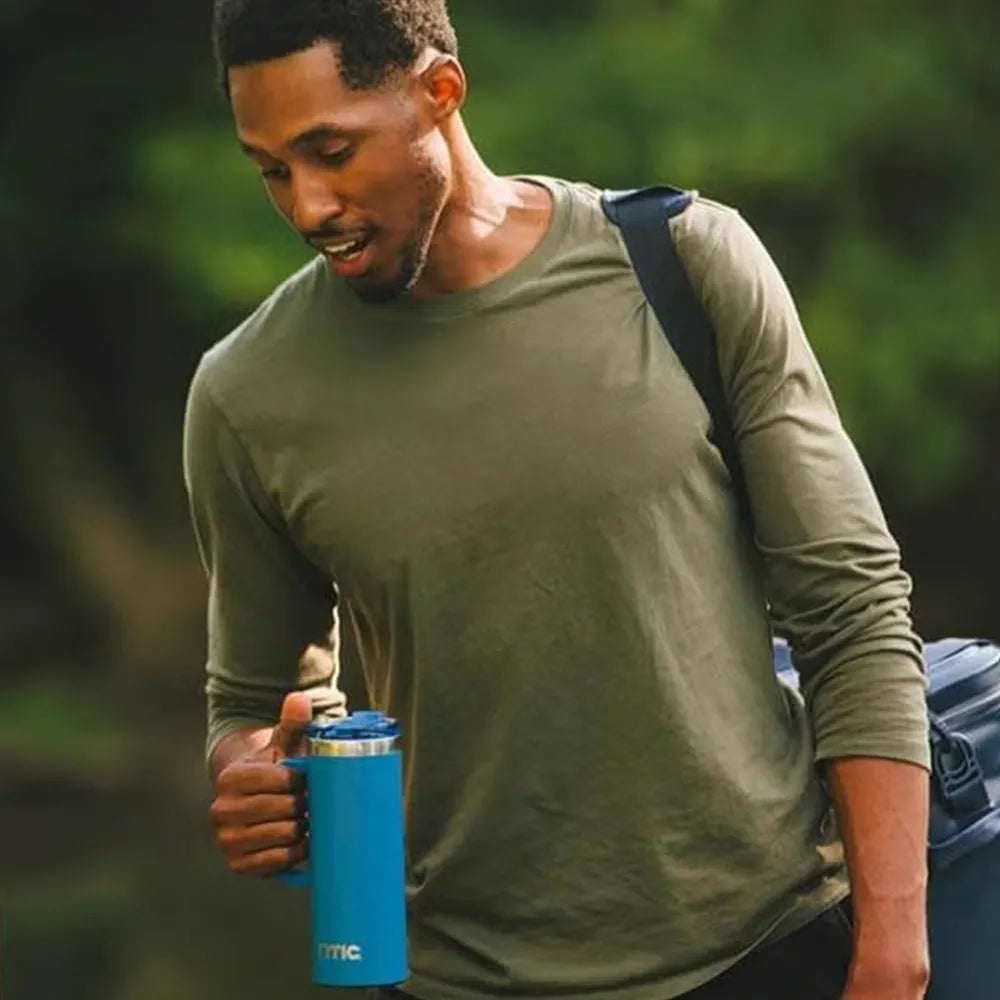 Man holding RTIC 20 oz Road Trip Travel Mug.