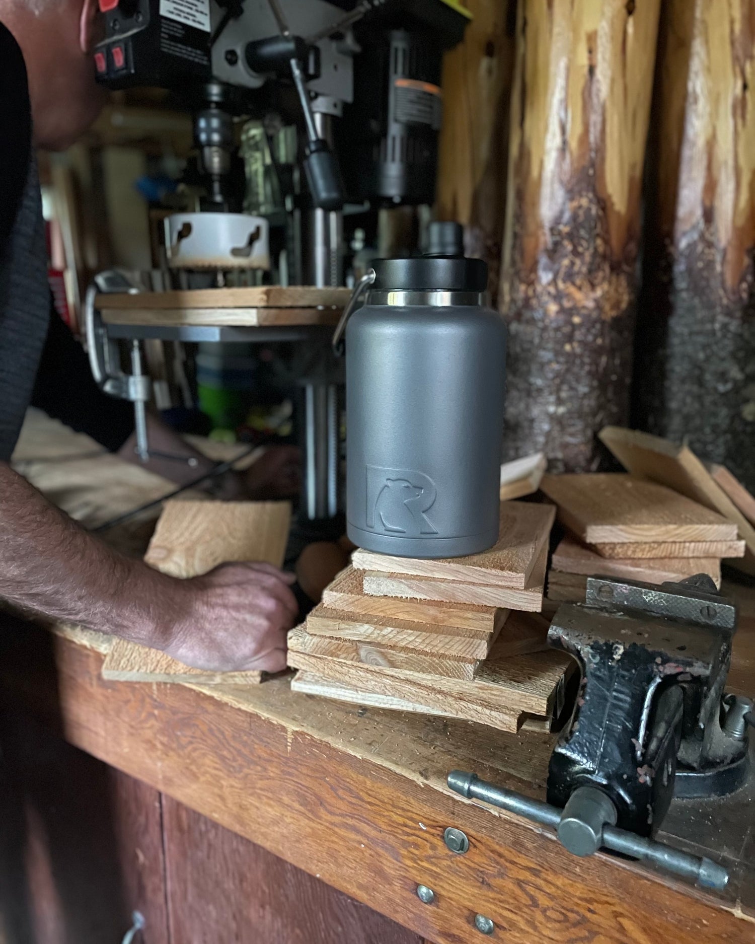 Man working in woodshop with RTIC gallon bottle jug