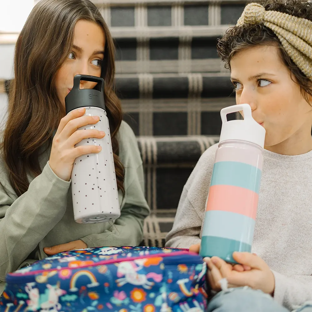 Two women drinking from Summit Water Bottle 18 ounce with straw lid.
