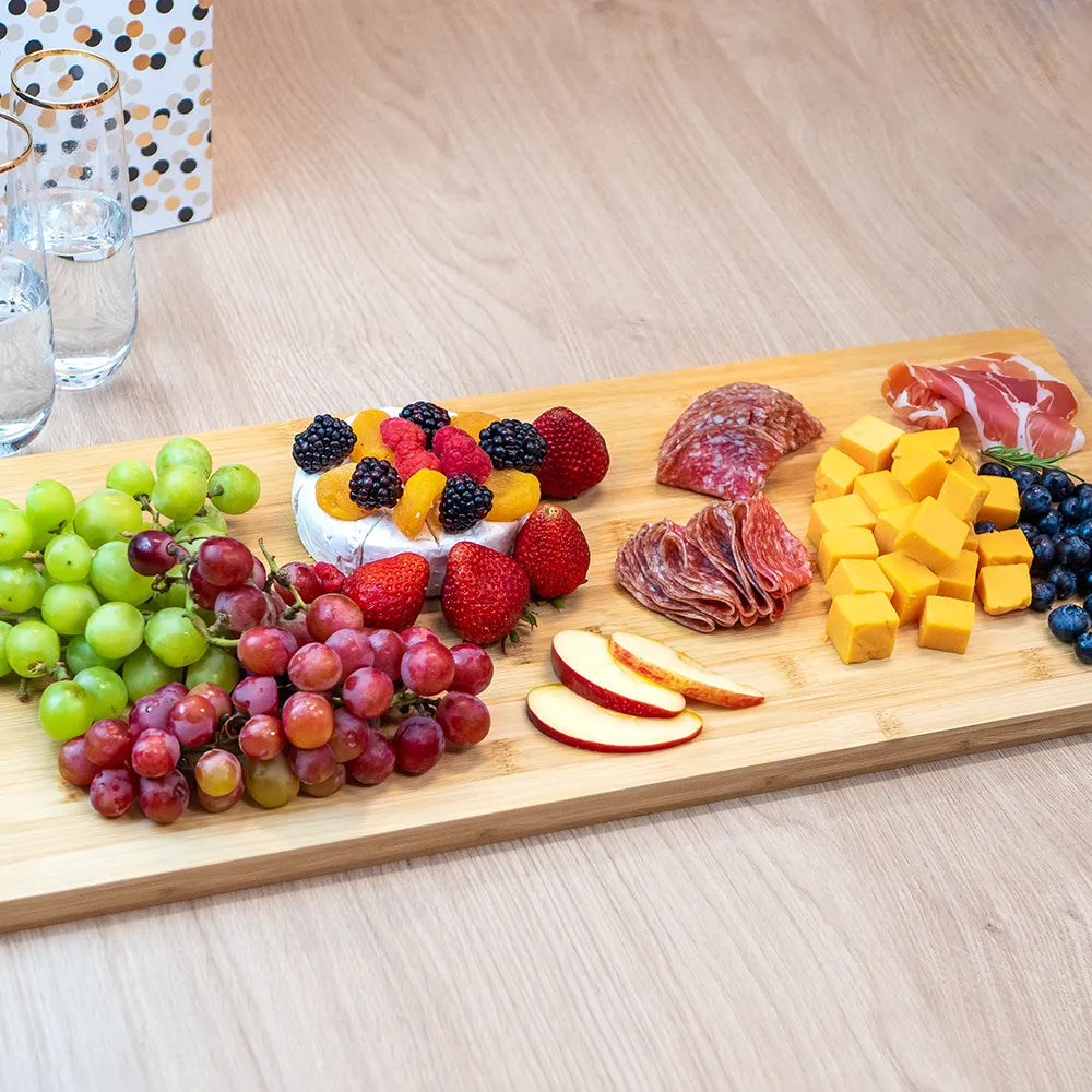 Custom Branding charcuterie board with meats, cheeses and fruit on it. 
