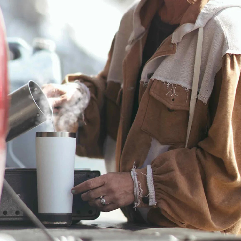 Woman pouring water into Vibe tumbler.