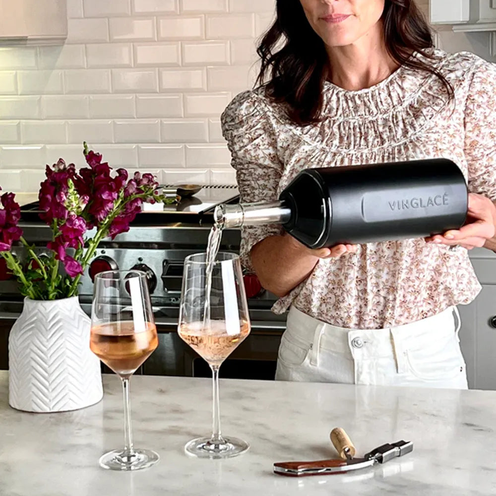 Woman pouring wine into glasses from bottle in Vinglace Original Wine &amp; Champagne Chiller.