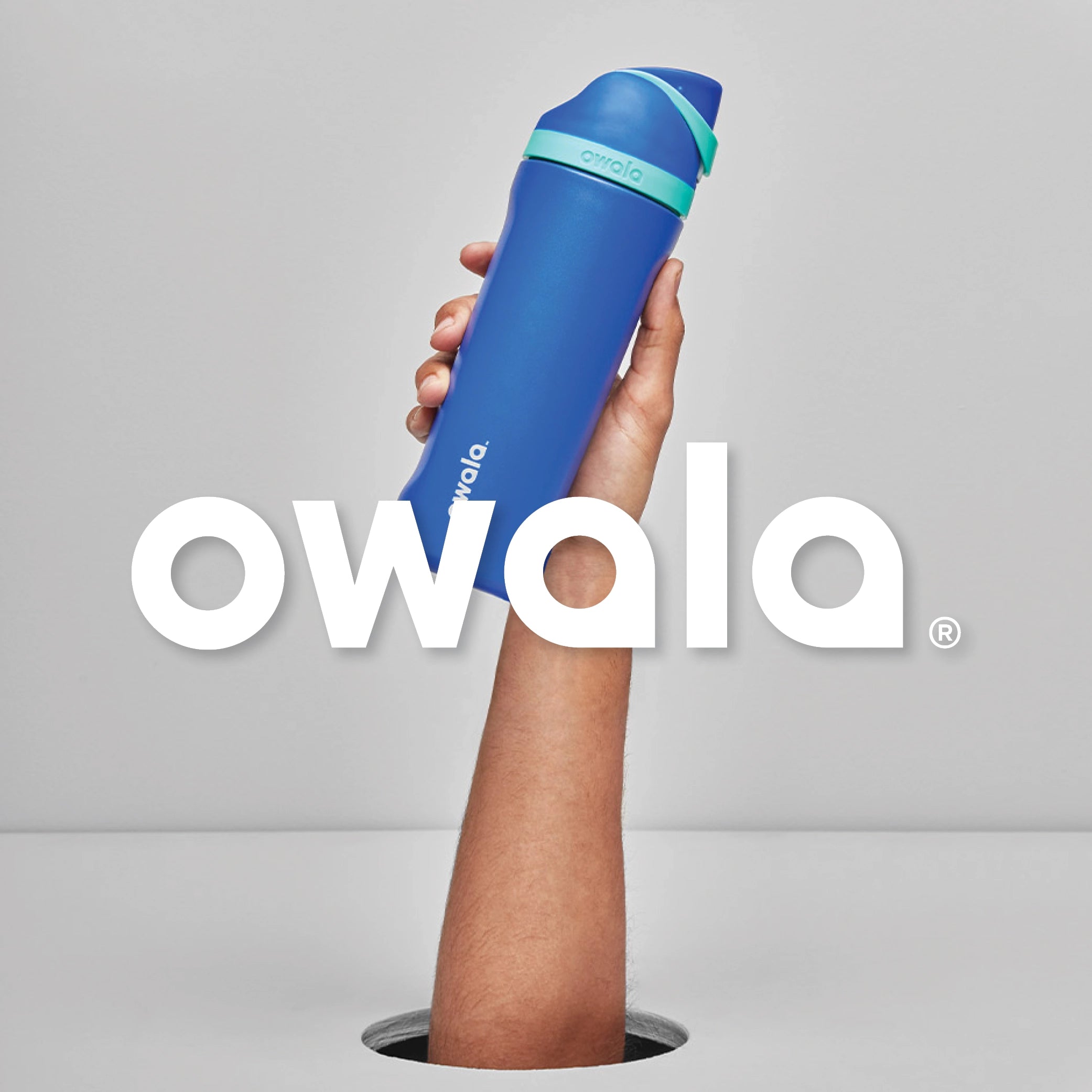 Person holding up a blue Owala Freesip water bottle