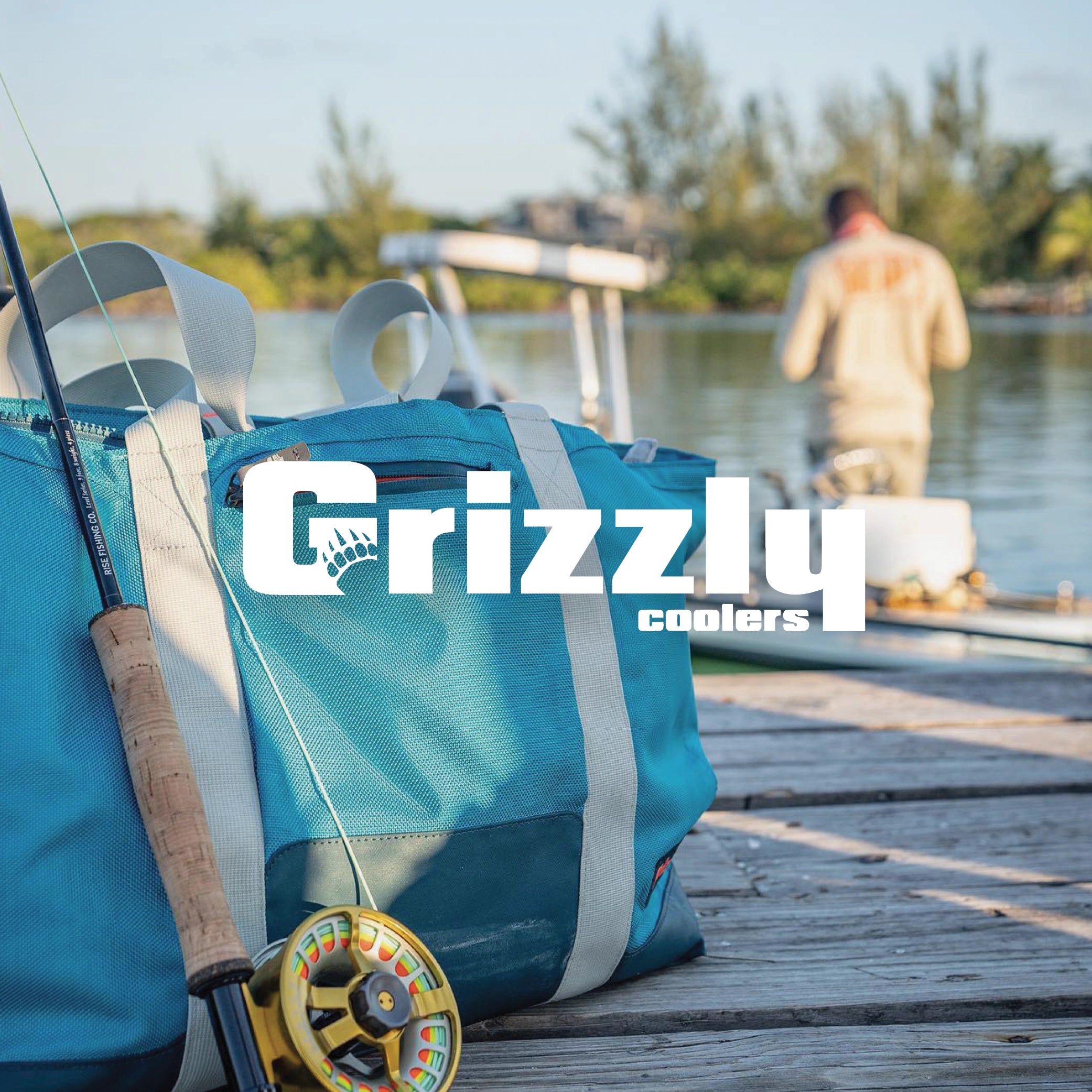 Grizzly Carry All Cooler on fishing dock with man fishing in background